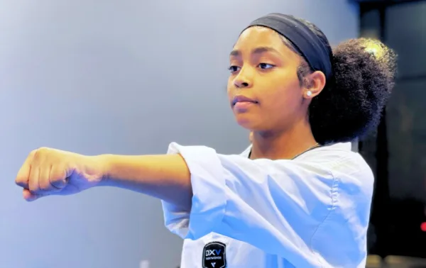 Teen student throwing a punch in class
